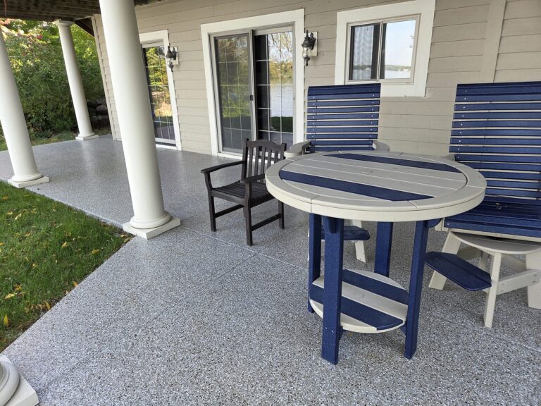 Covered porch flake floor with patio furniture in Oconomowoc