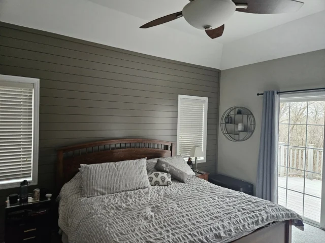 Bedroom with a painted accent wall and white trim