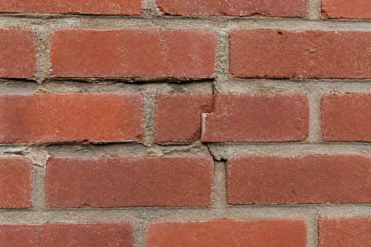 Illustration of deteriorated mortar joints and localized cracking in exterior brick