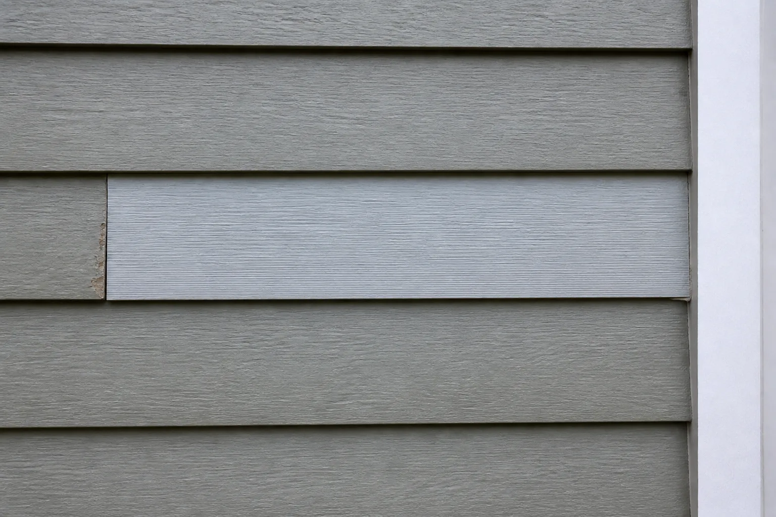Illustration of a properly aligned replacement engineered wood siding board installed before repainting