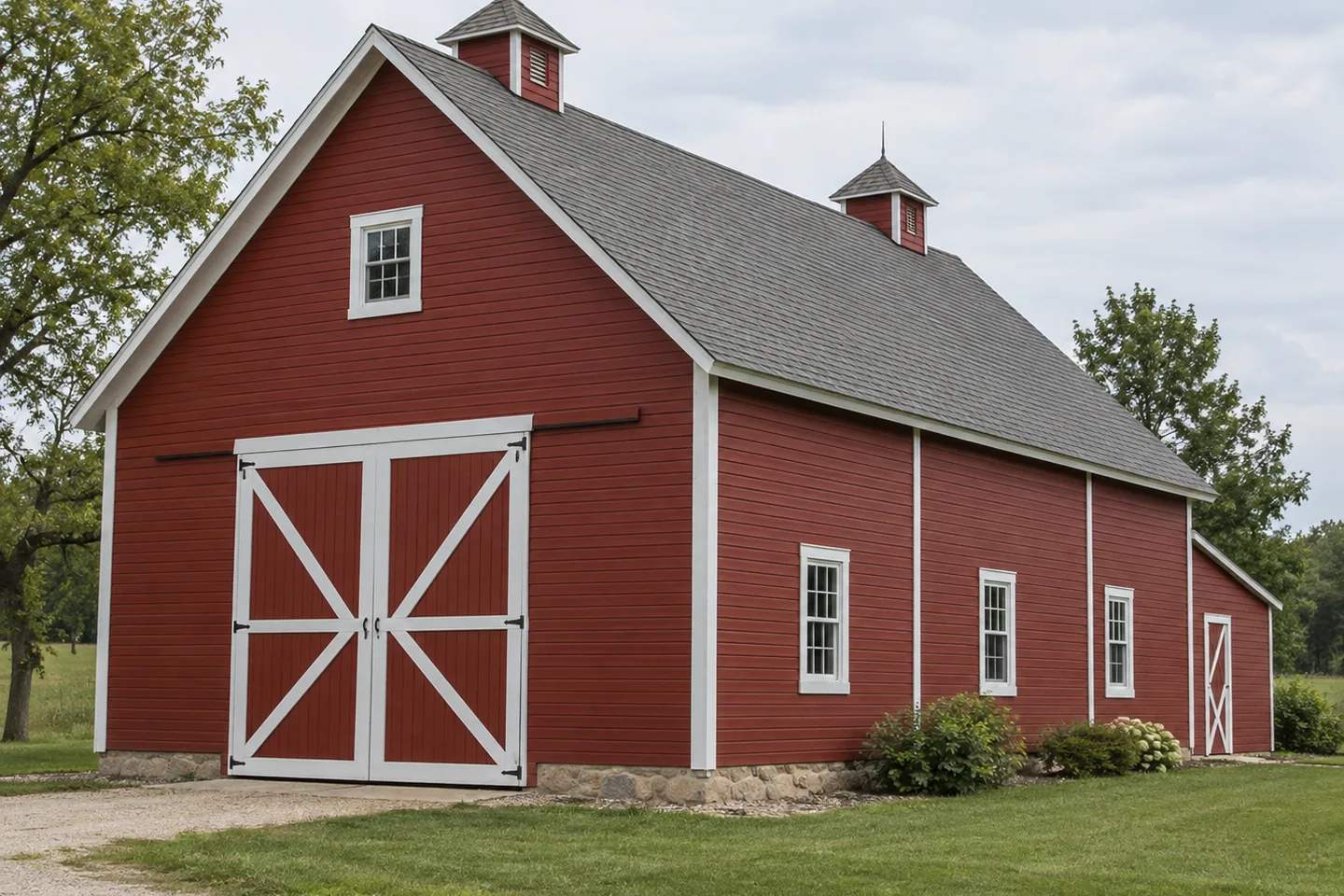 Red painted wood-sided barn with white trim