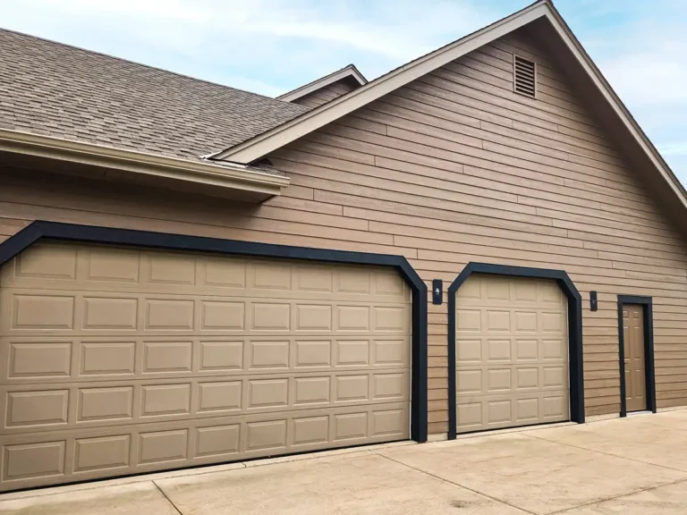Tan LP SmartSide garage with dark trim on an Eagle home after exterior painting