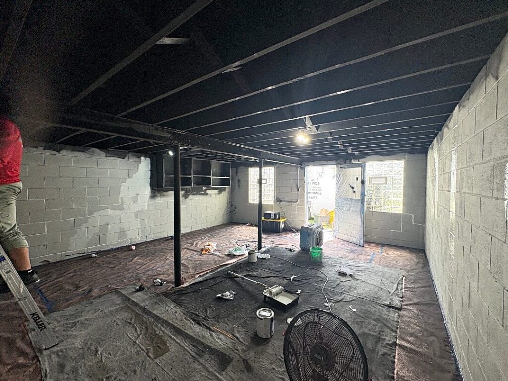 Basement black ceiling gray floor in North Prairie