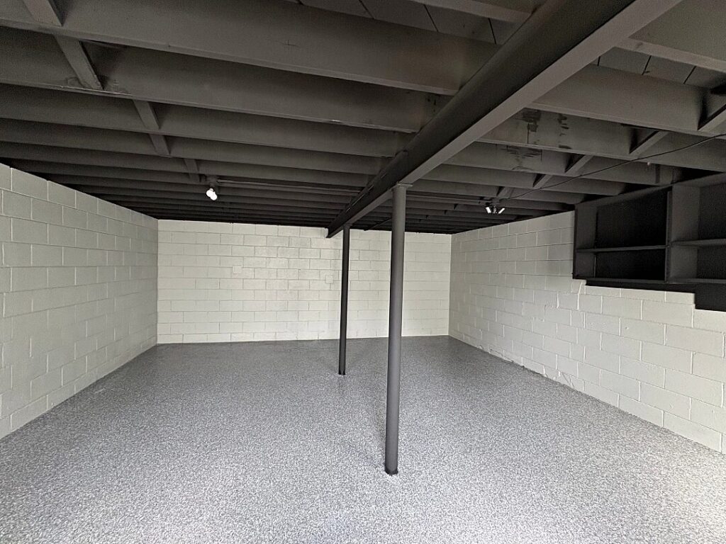 Basement black ceiling gray floor in North Prairie