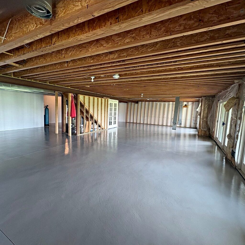 Unfinished basement in North Prairie with a newly coated gray epoxy floor