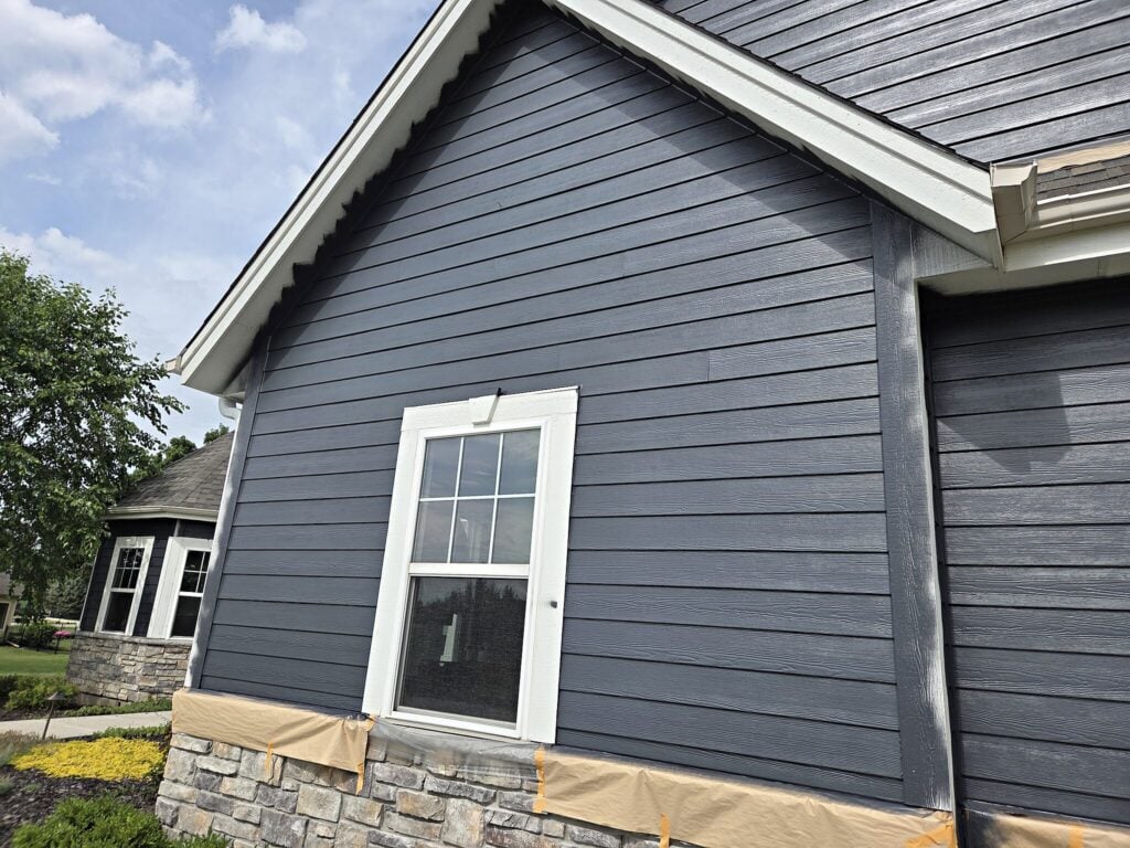 Blue-gray LP SmartSide siding with white trim in Mukwonago