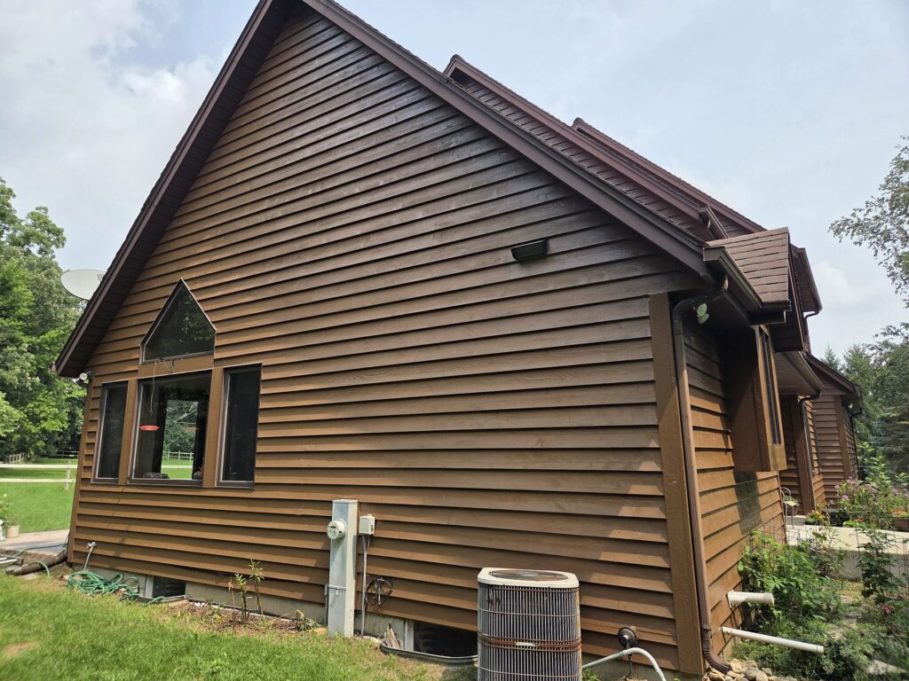 Brown cedar siding on the side of an Eagle home