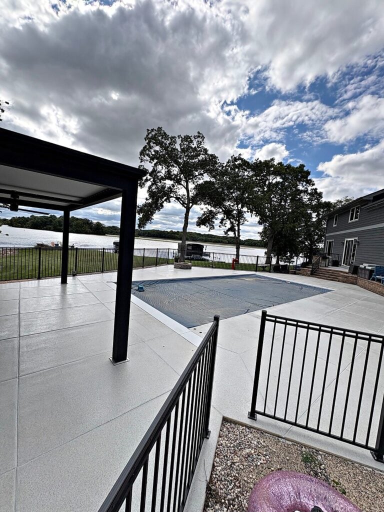 Covered patio gray floor black posts in Waterford