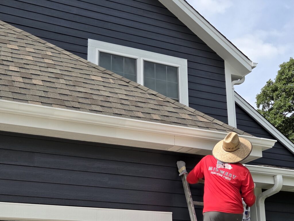 Midwest Painting Pros crew painting exterior trim on a Mukwonago home