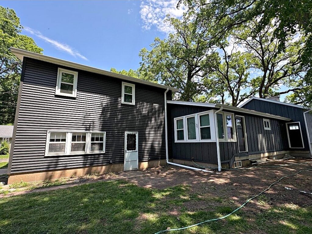 Dark house exterior white trim in West Bend