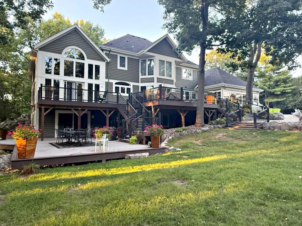 Dark house tall windows deck in Colgate