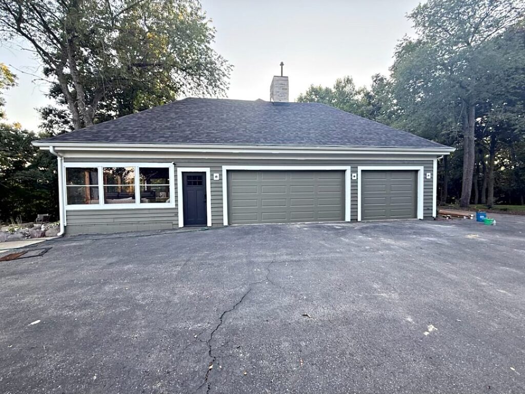 Gray garage exterior white trim in Colgate