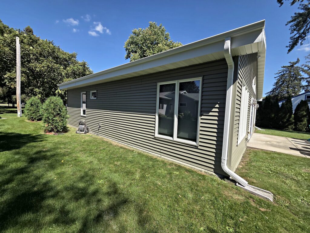 Gray vinyl siding and white trim on a home in Palmyra after repainting