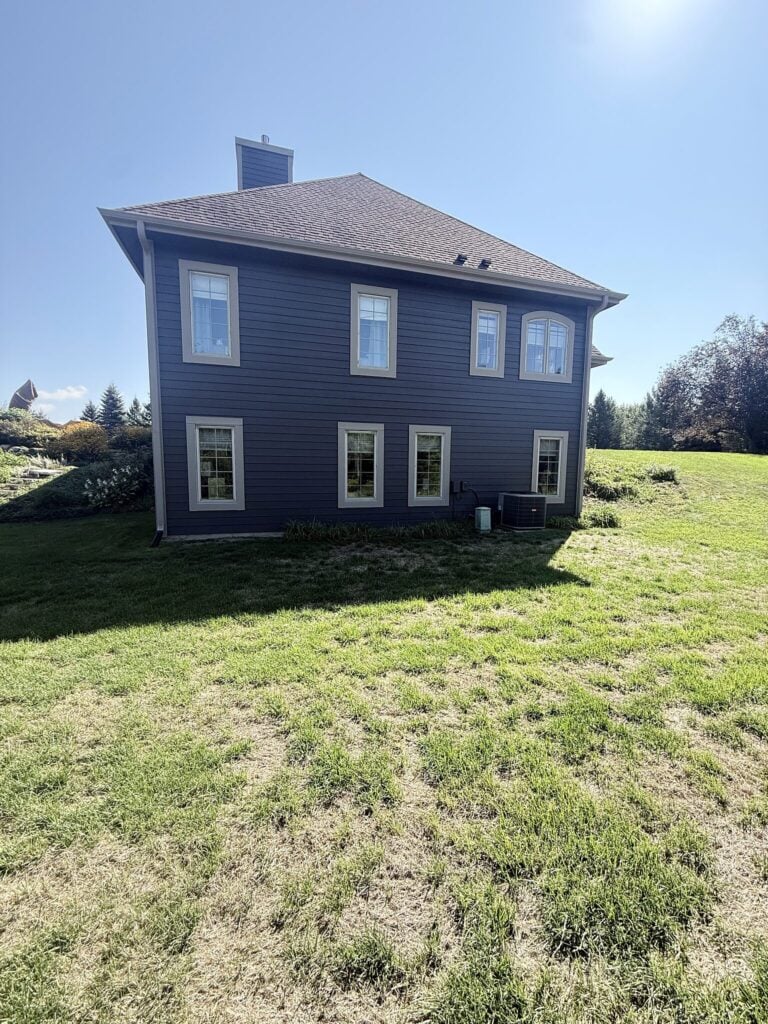 Blue-gray two-story home in East Troy after exterior painting