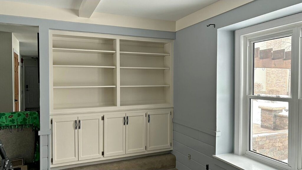Living room with light gray walls and white painted built-in shelves in Waukesha